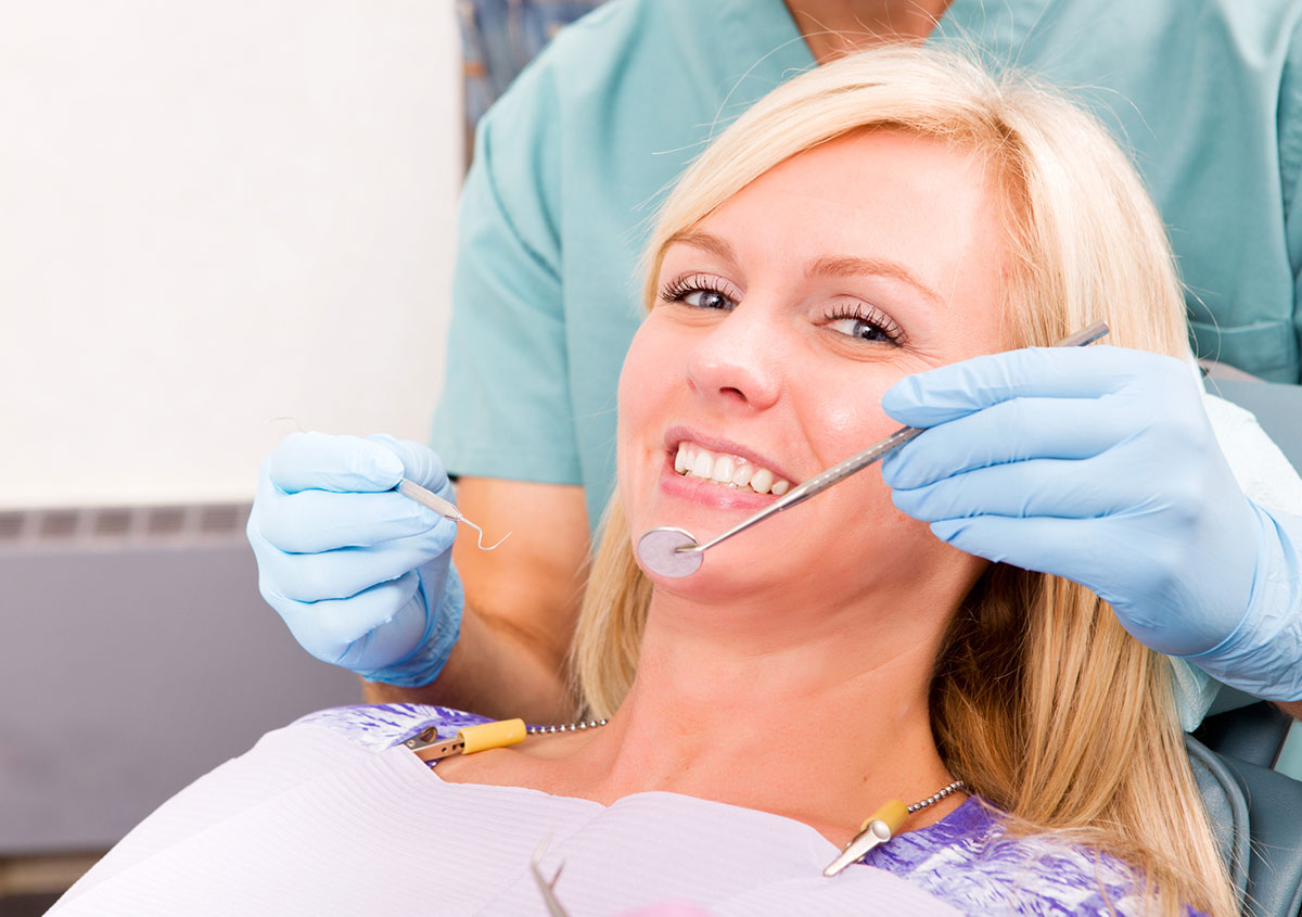 A woman is having dental checkup
