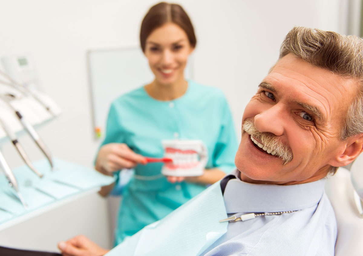 A senior man is smiling at dental