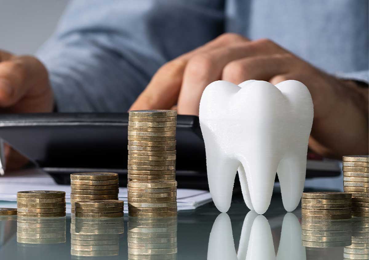 A tooth modal and bunch of coins on a dentist's desk