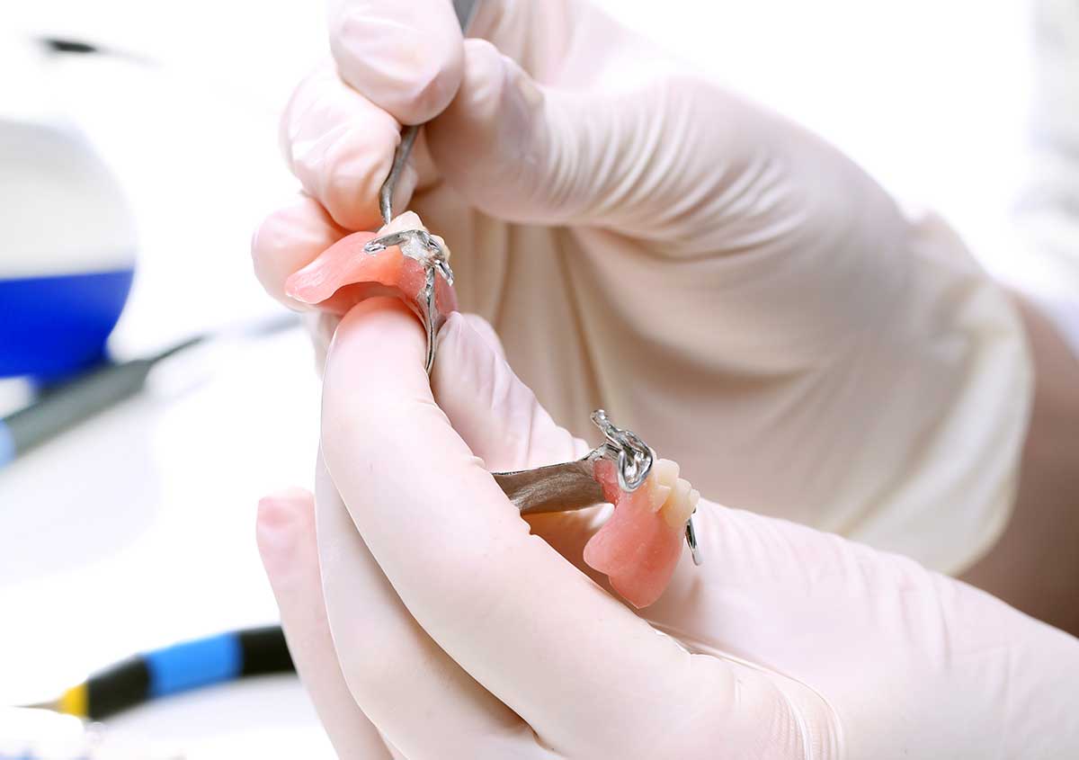 Dental technician working on a denture