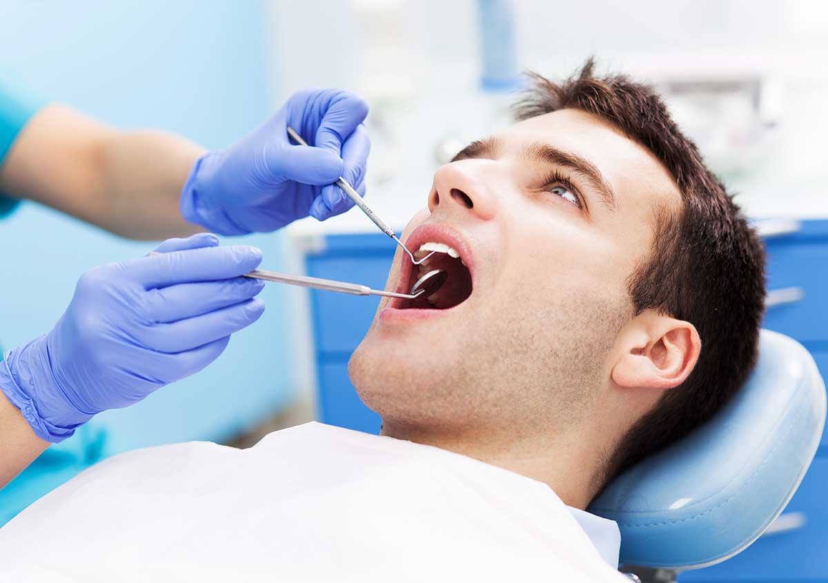 Male patient getting dental checkup