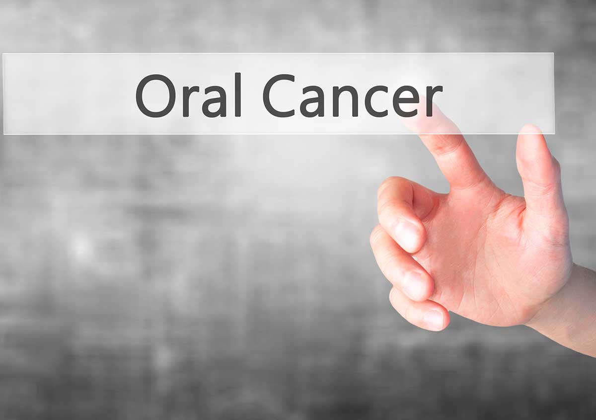 Oral Cancer - Hand pressing a button on blurred background conce