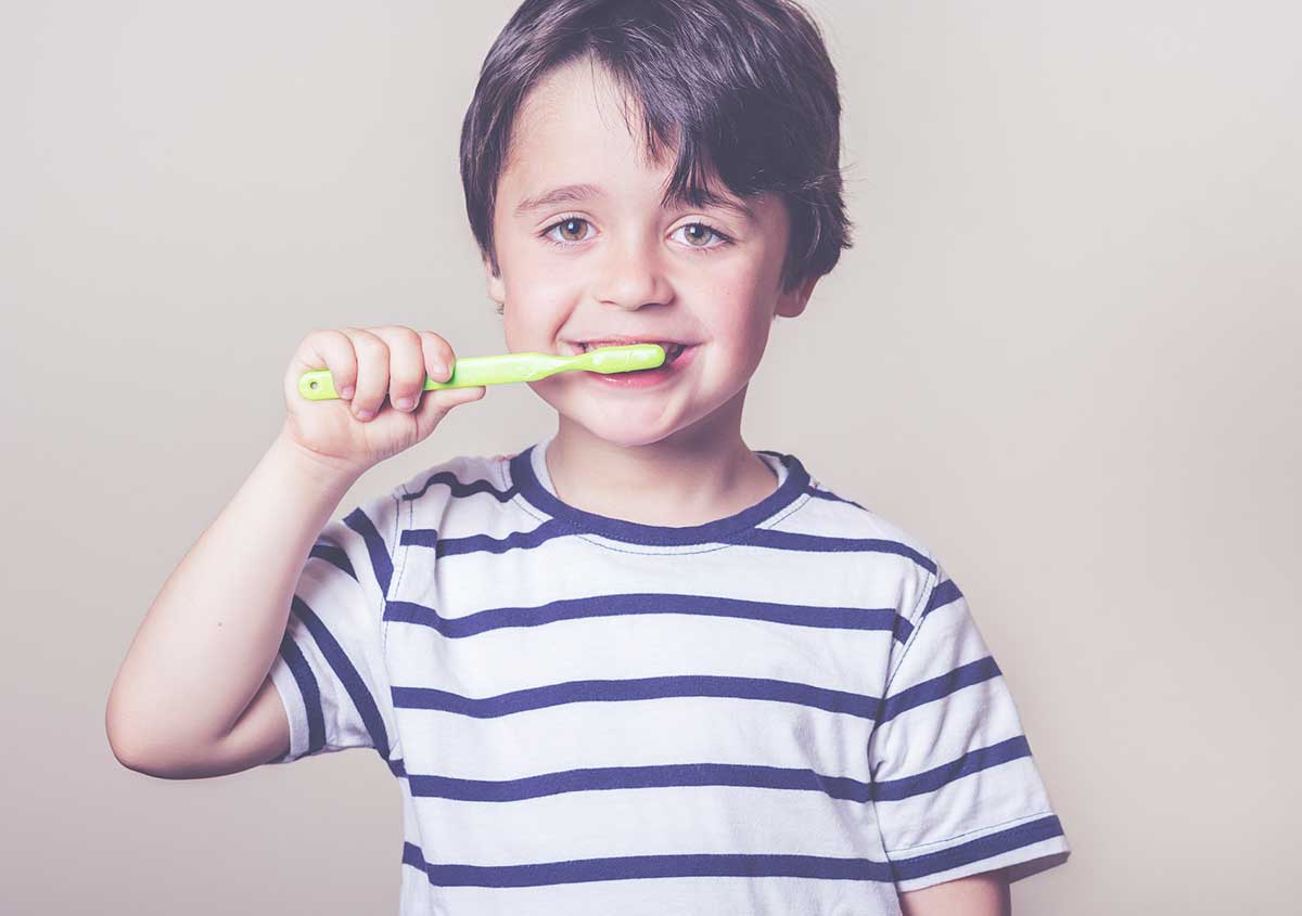 Happy child brushes his teeth